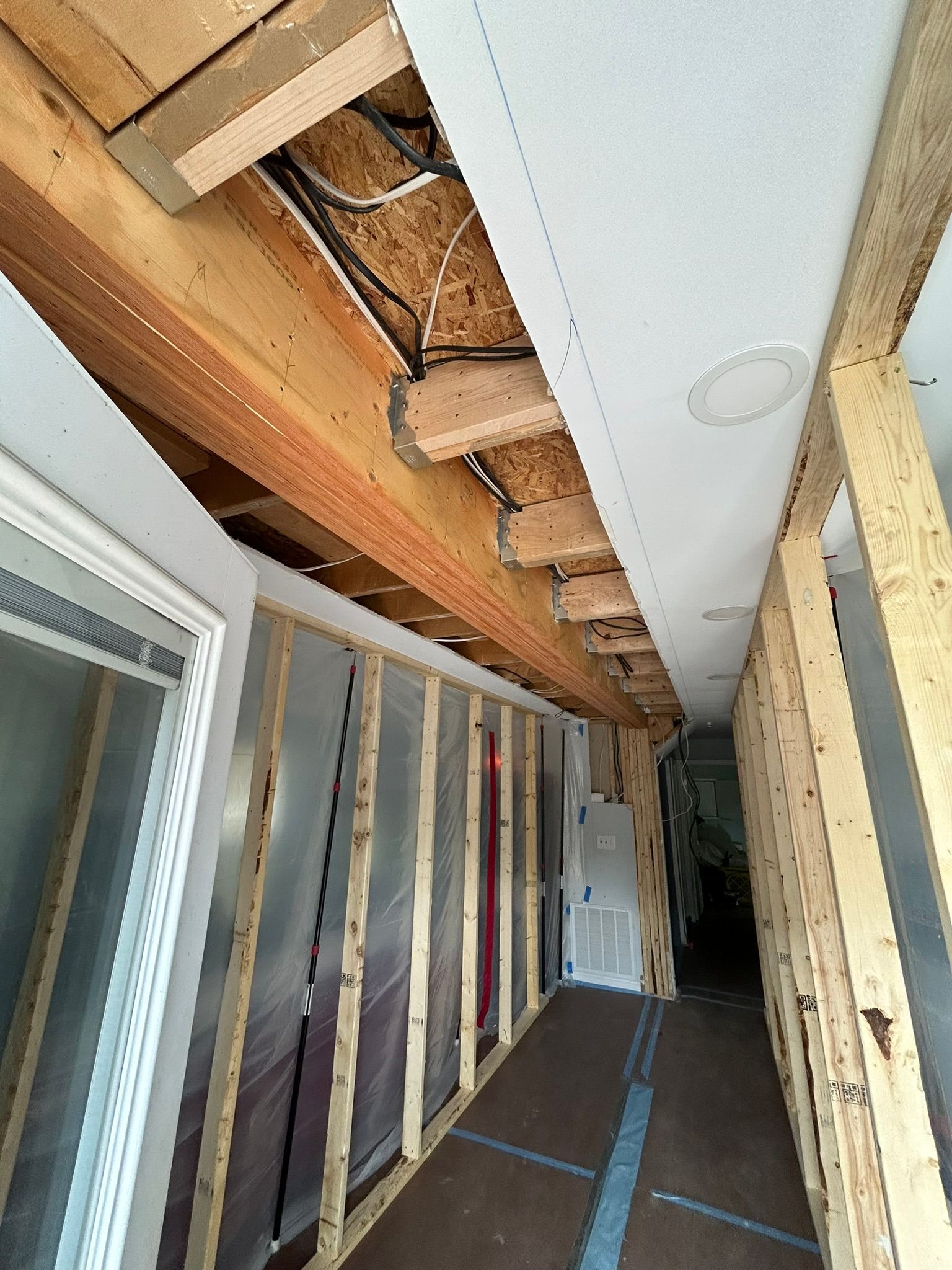 A long hallway with a ceiling that is being built.