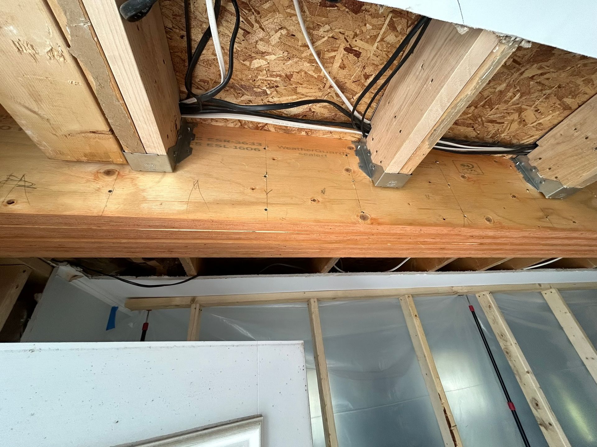 A wooden ceiling with a lot of wires coming out of it.