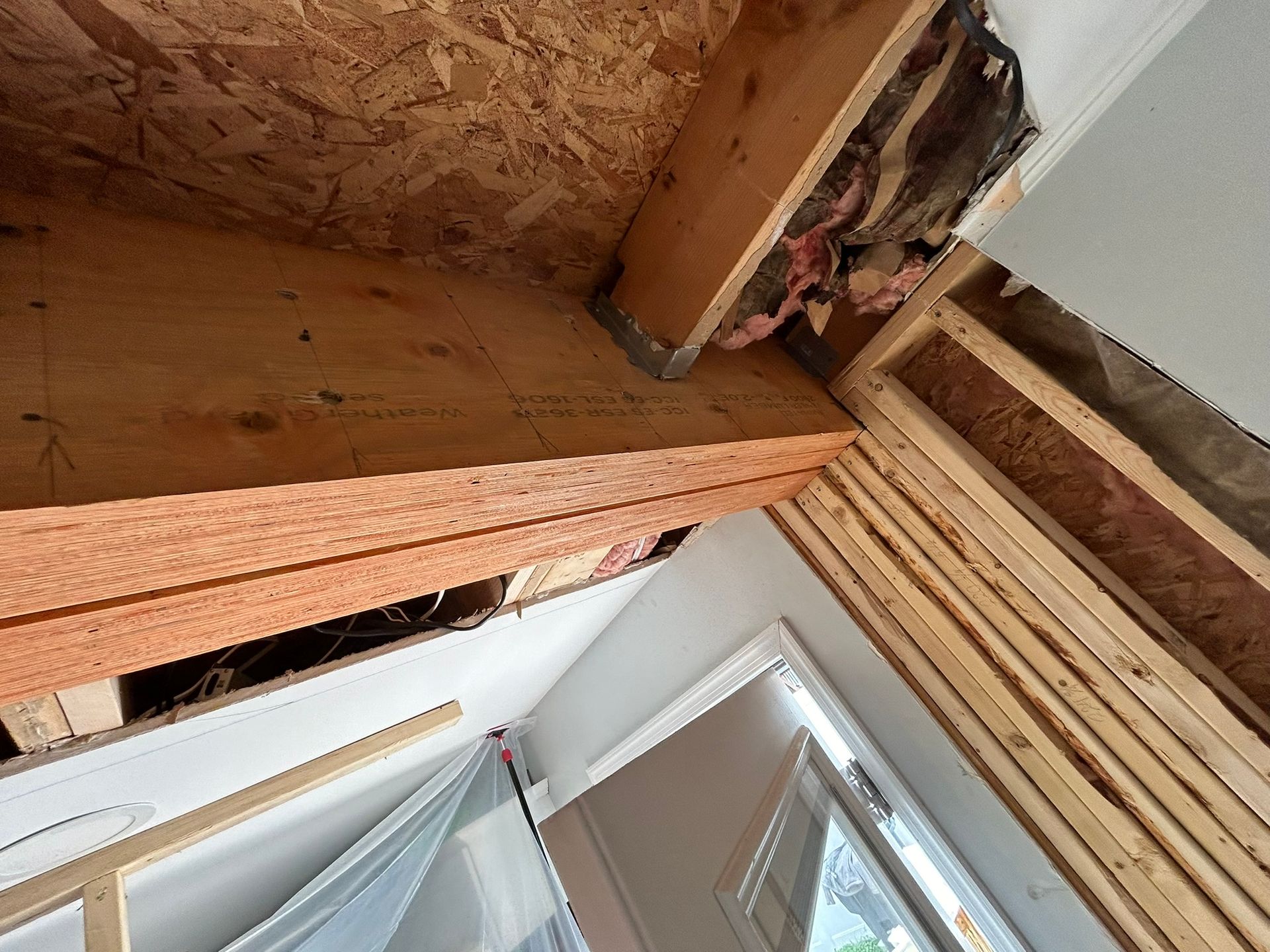 A room with a lot of wooden beams and a window.