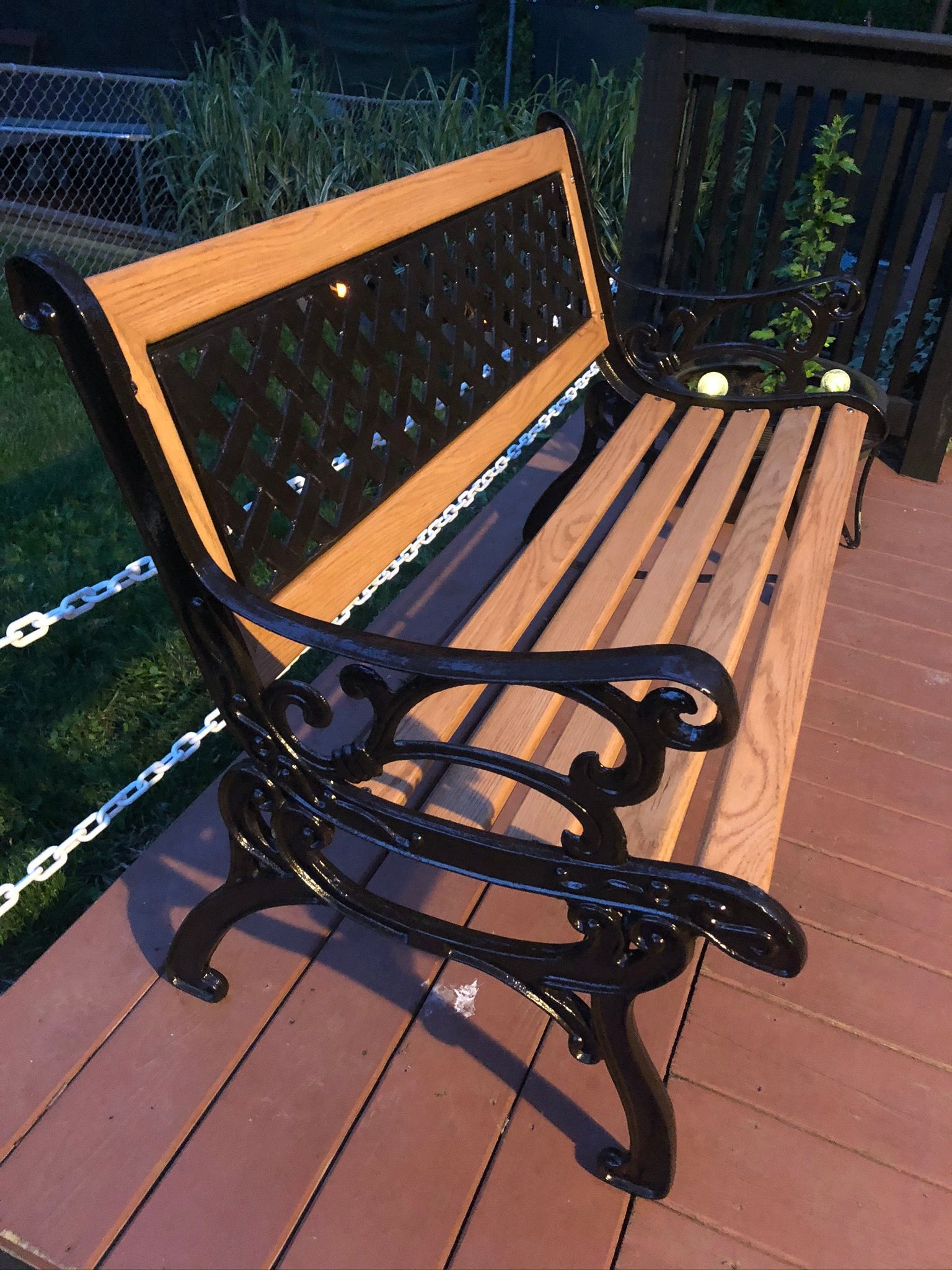 A wooden bench is sitting on a wooden deck