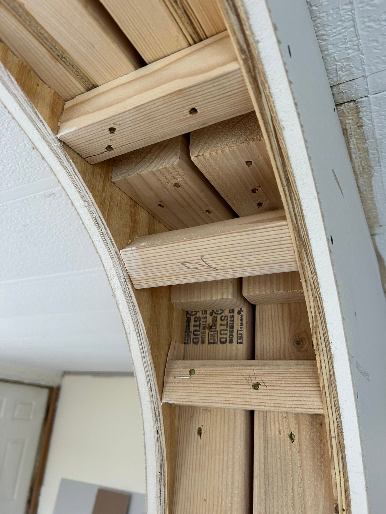 A wooden archway is being built in a room.