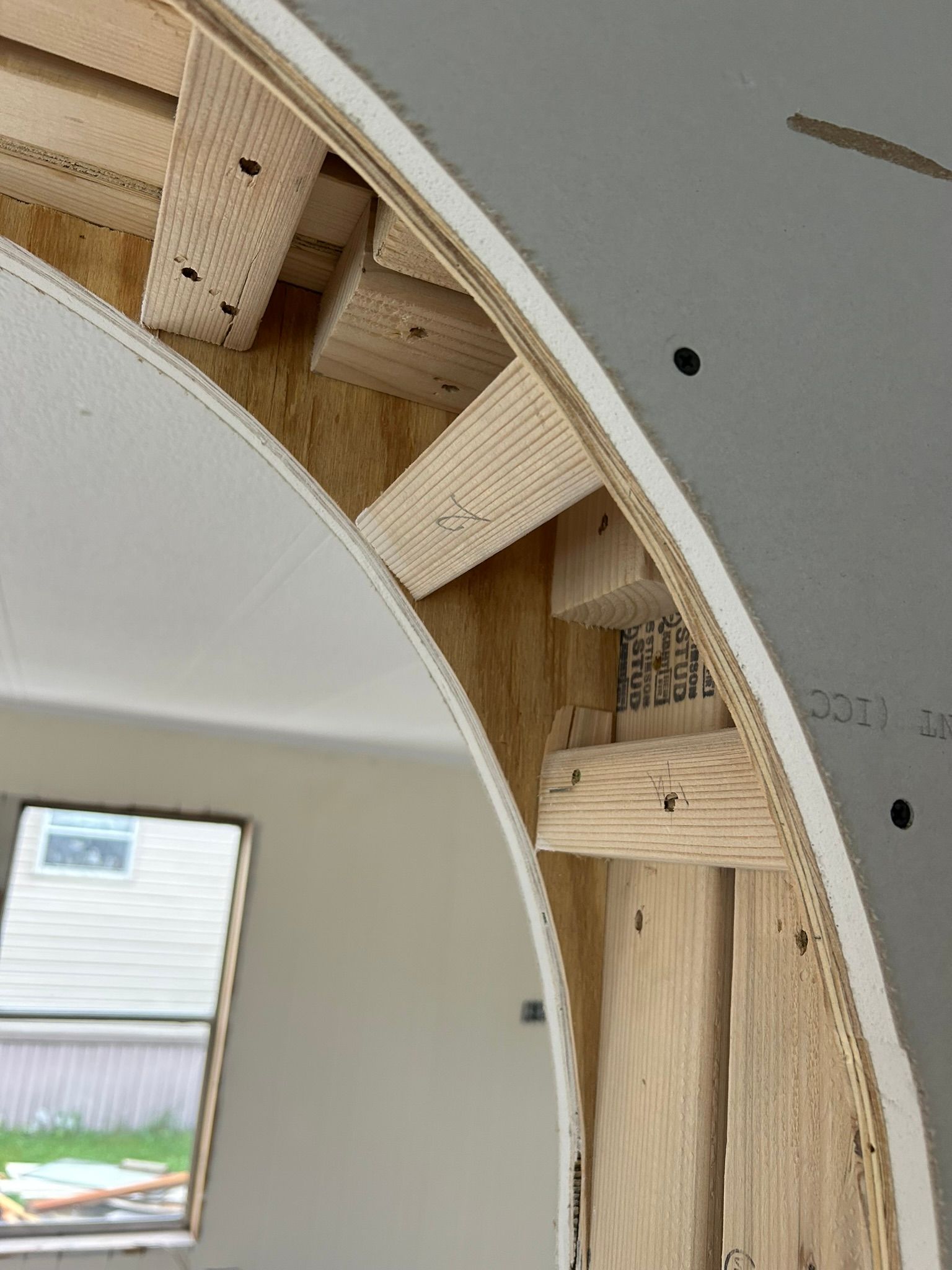 A room with a window and a ceiling that is being built