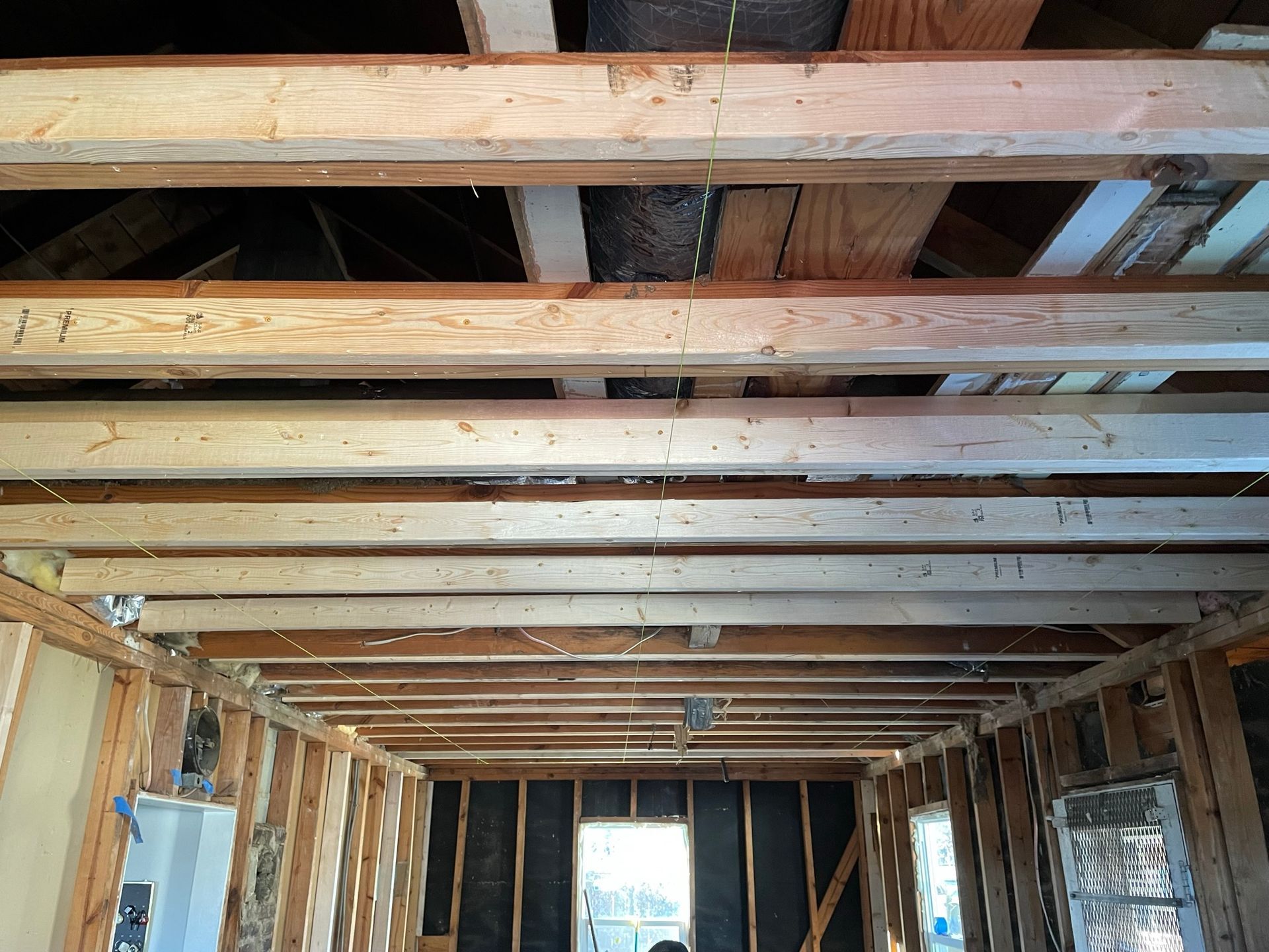 The ceiling of a house is being built with wooden beams.