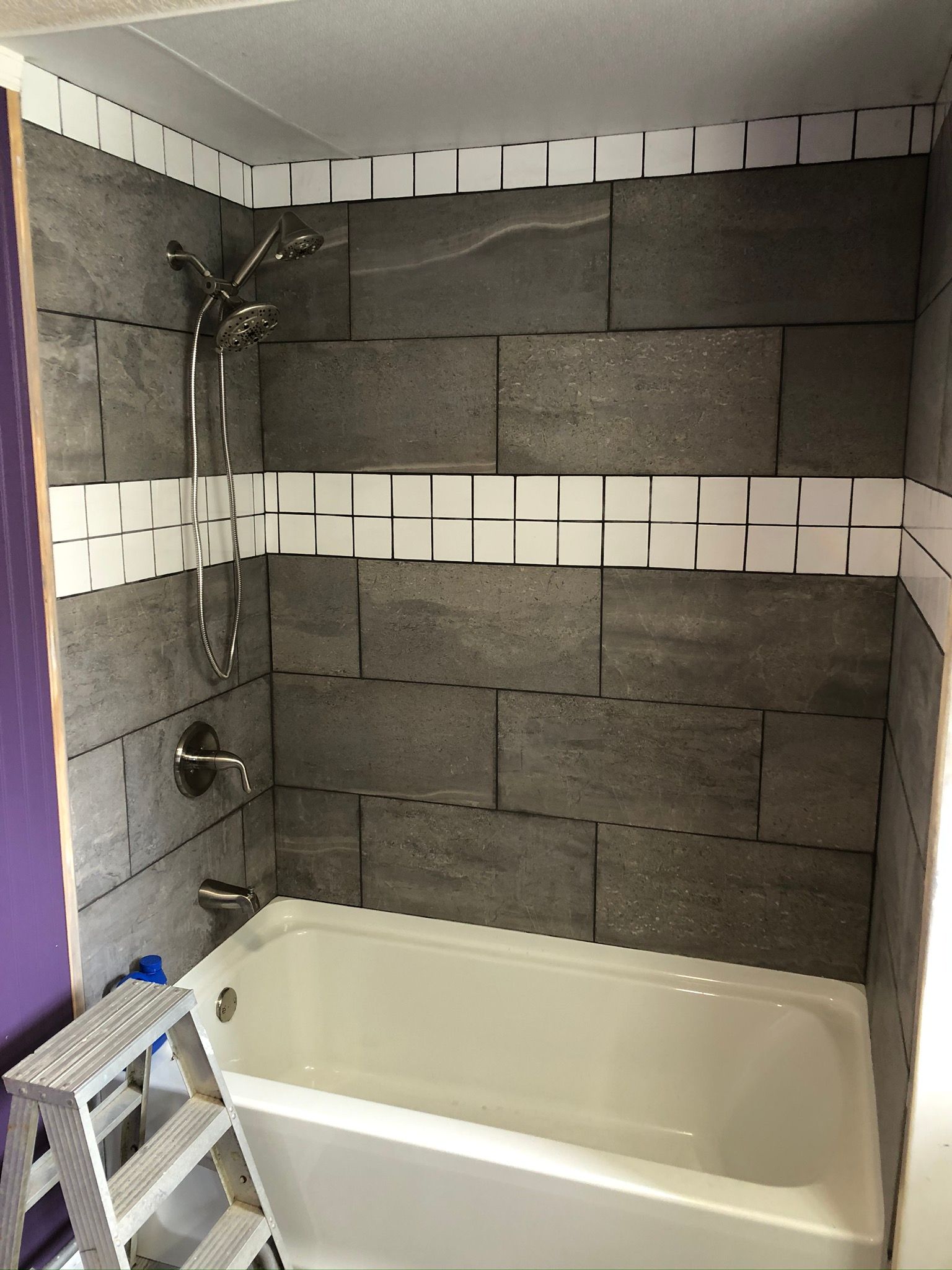 A bathroom with a bathtub and a shower.