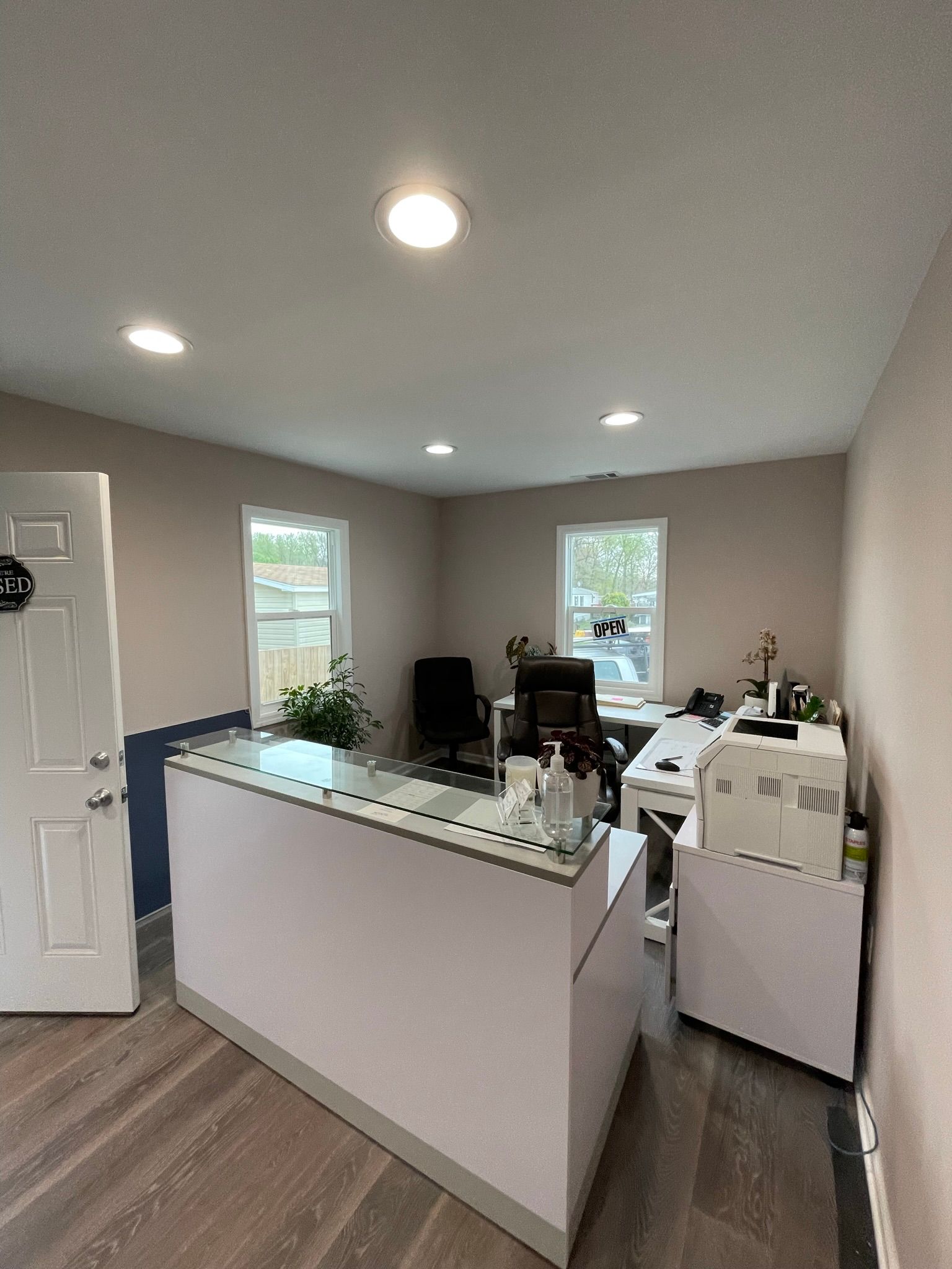 A room with a desk , chair , computer and printer.