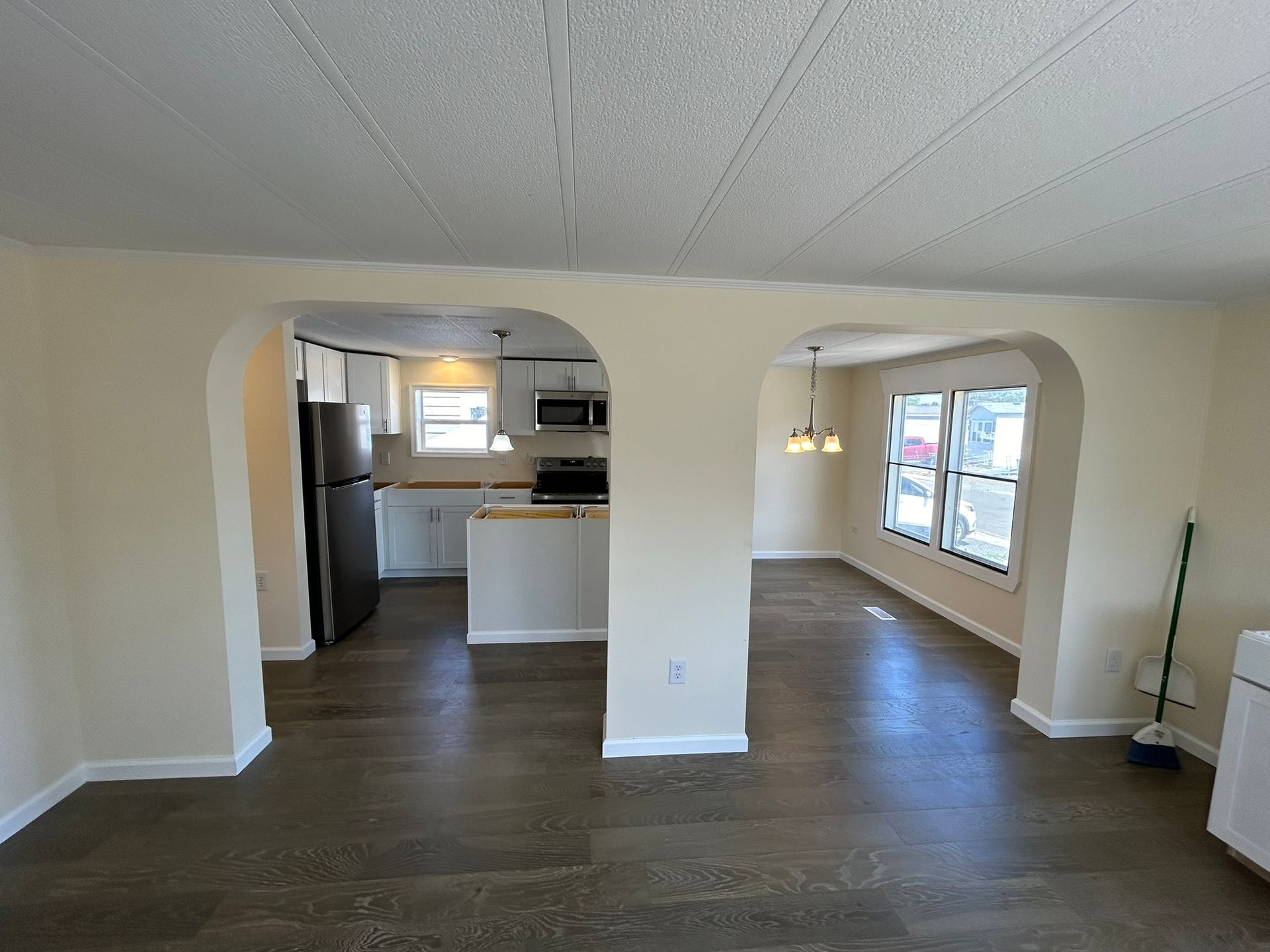 An empty house with a kitchen and a living room