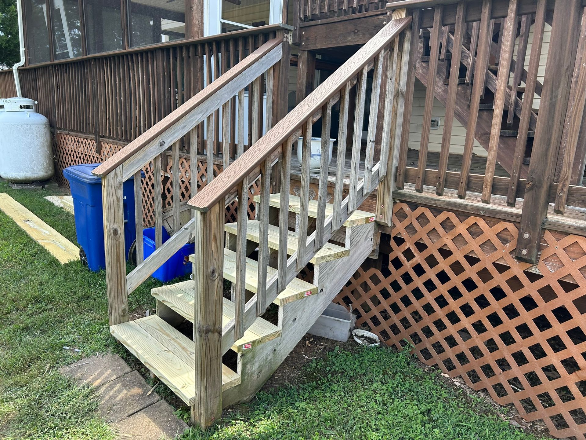 A wooden deck with stairs leading up to it.