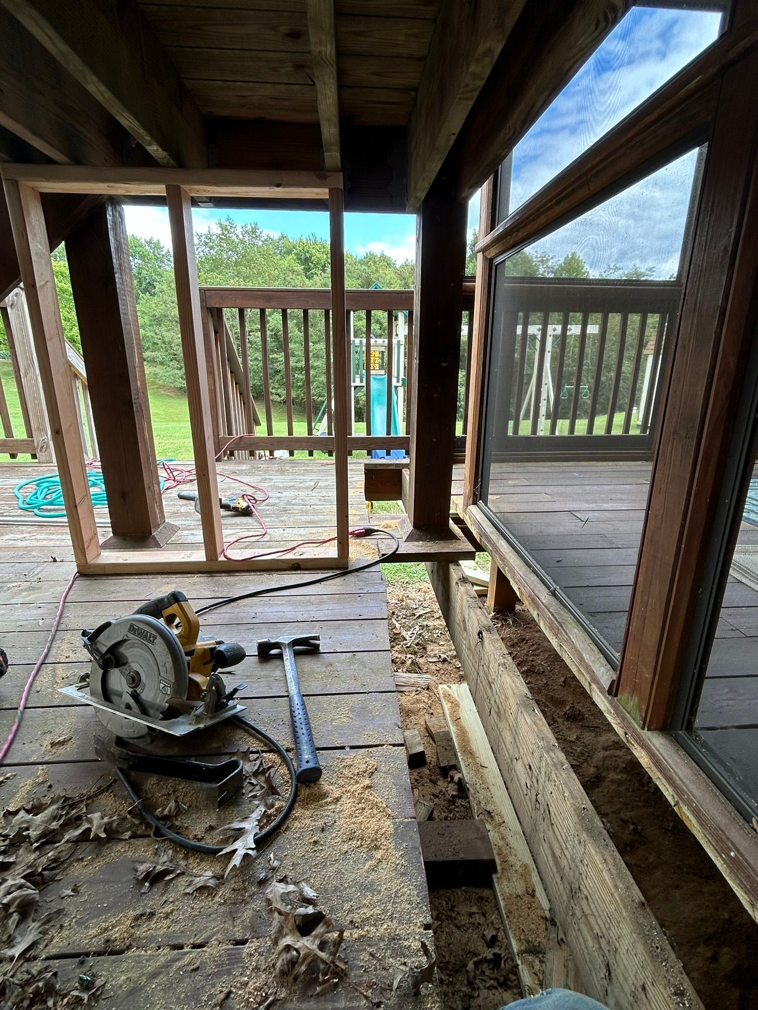 A circular saw is sitting on the floor of a building under construction.