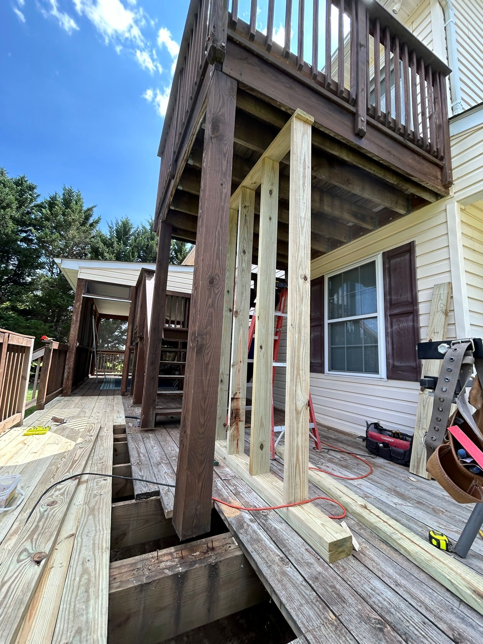 A wooden deck is being built on top of a house.