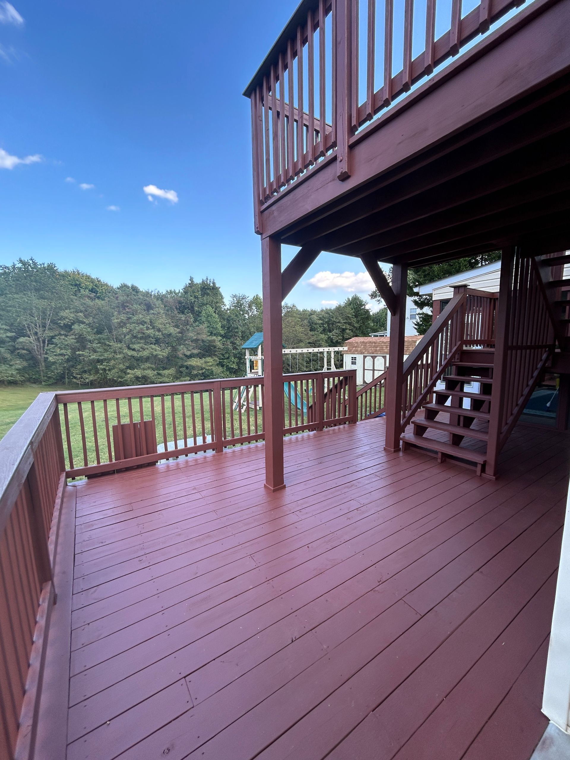A large wooden deck with stairs leading up to it