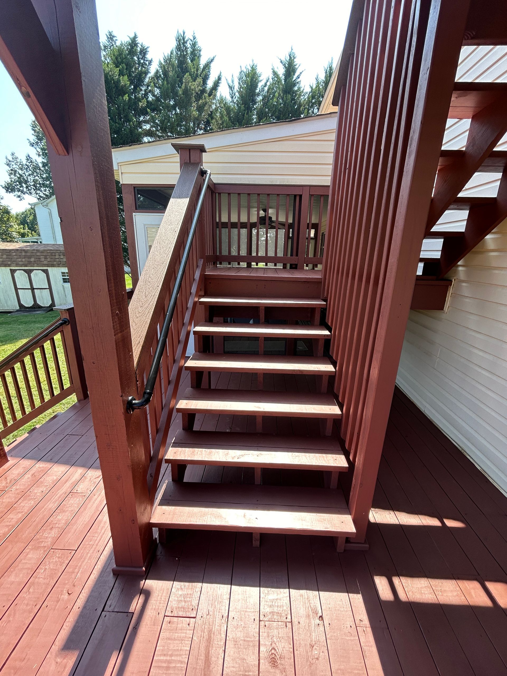 A set of wooden stairs leading up to a deck.