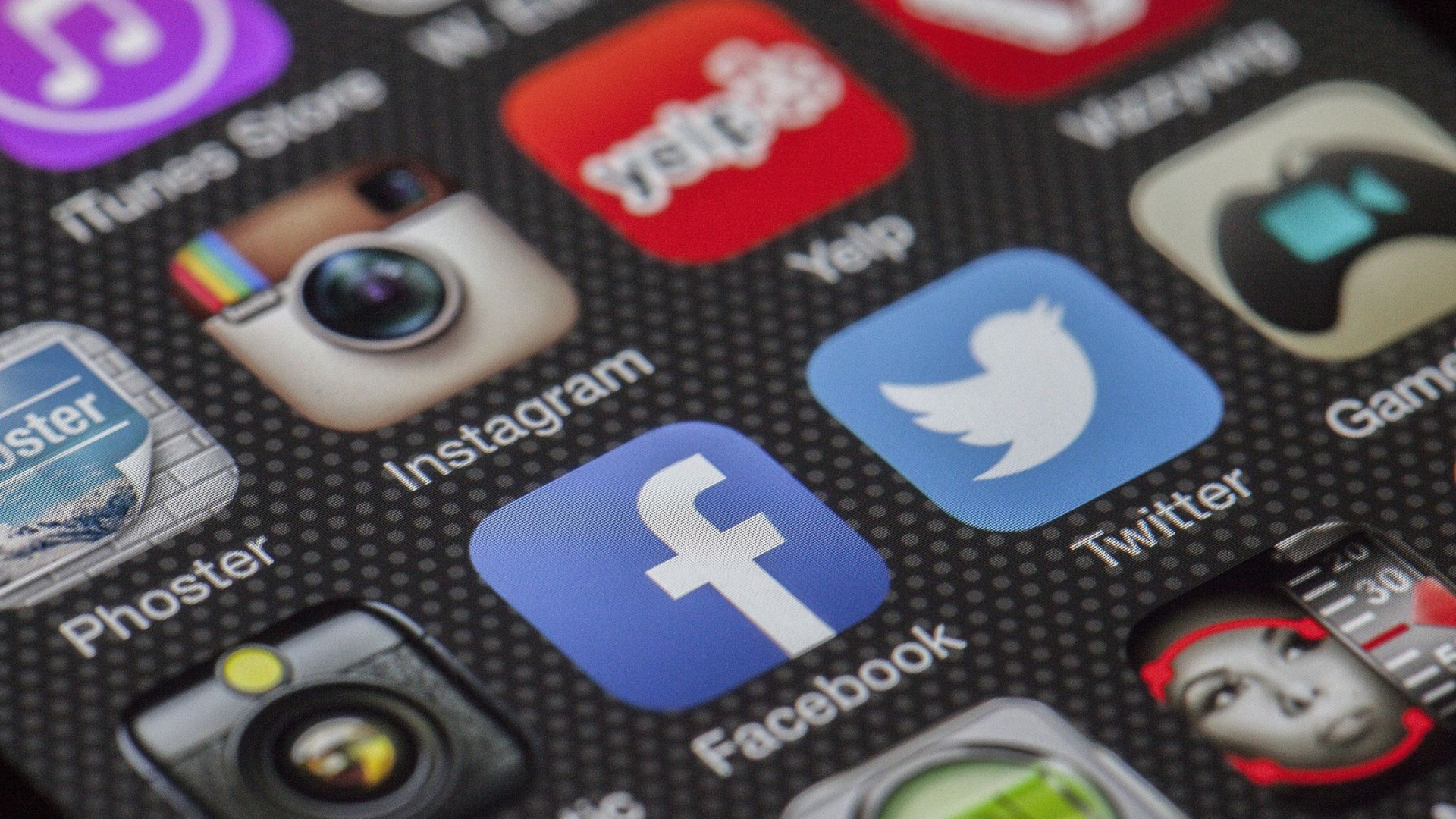Close-up of social media app icons on a smartphone screen, including Instagram, Facebook, Twitter, and others