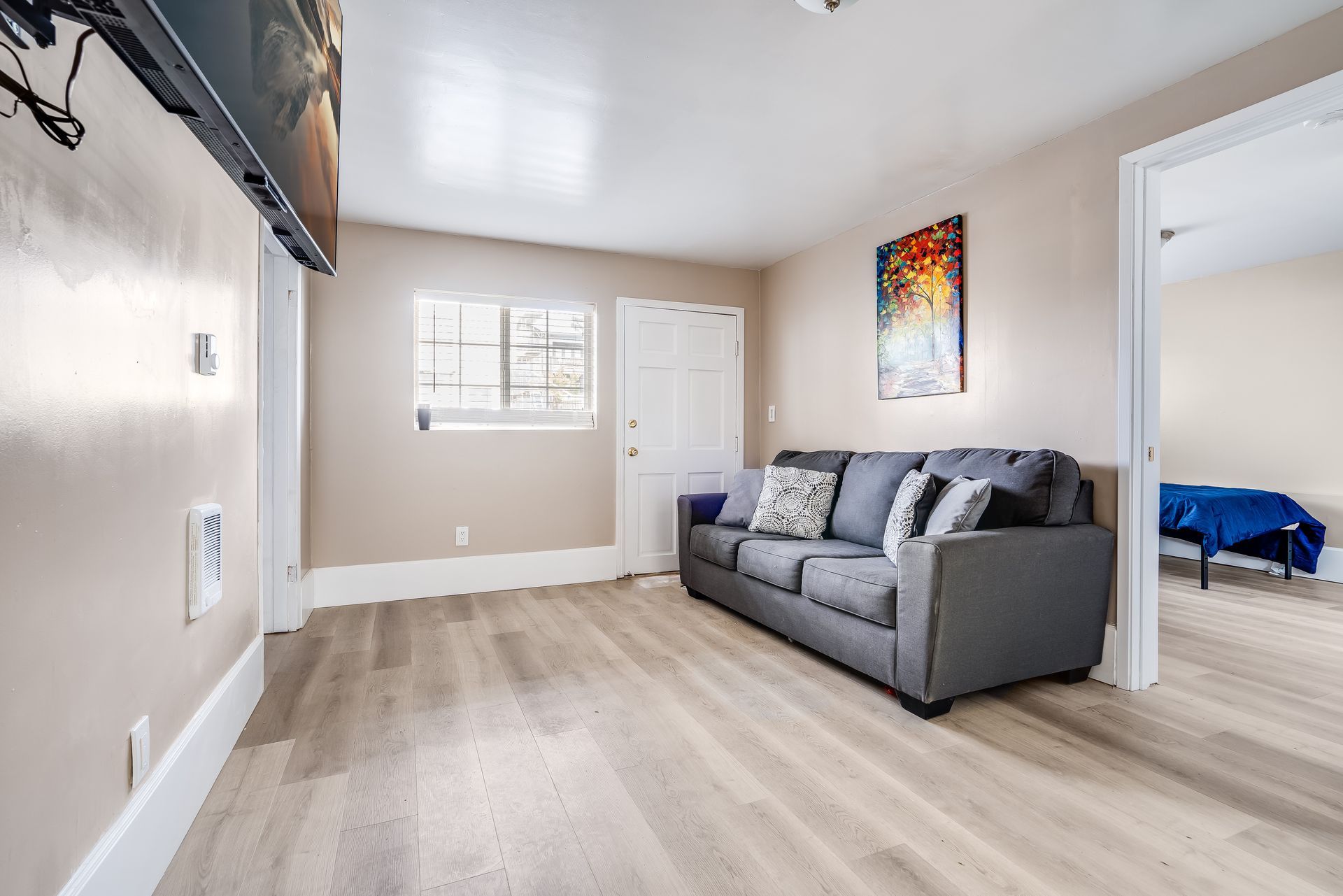 A living room with a couch and a flat screen tv.