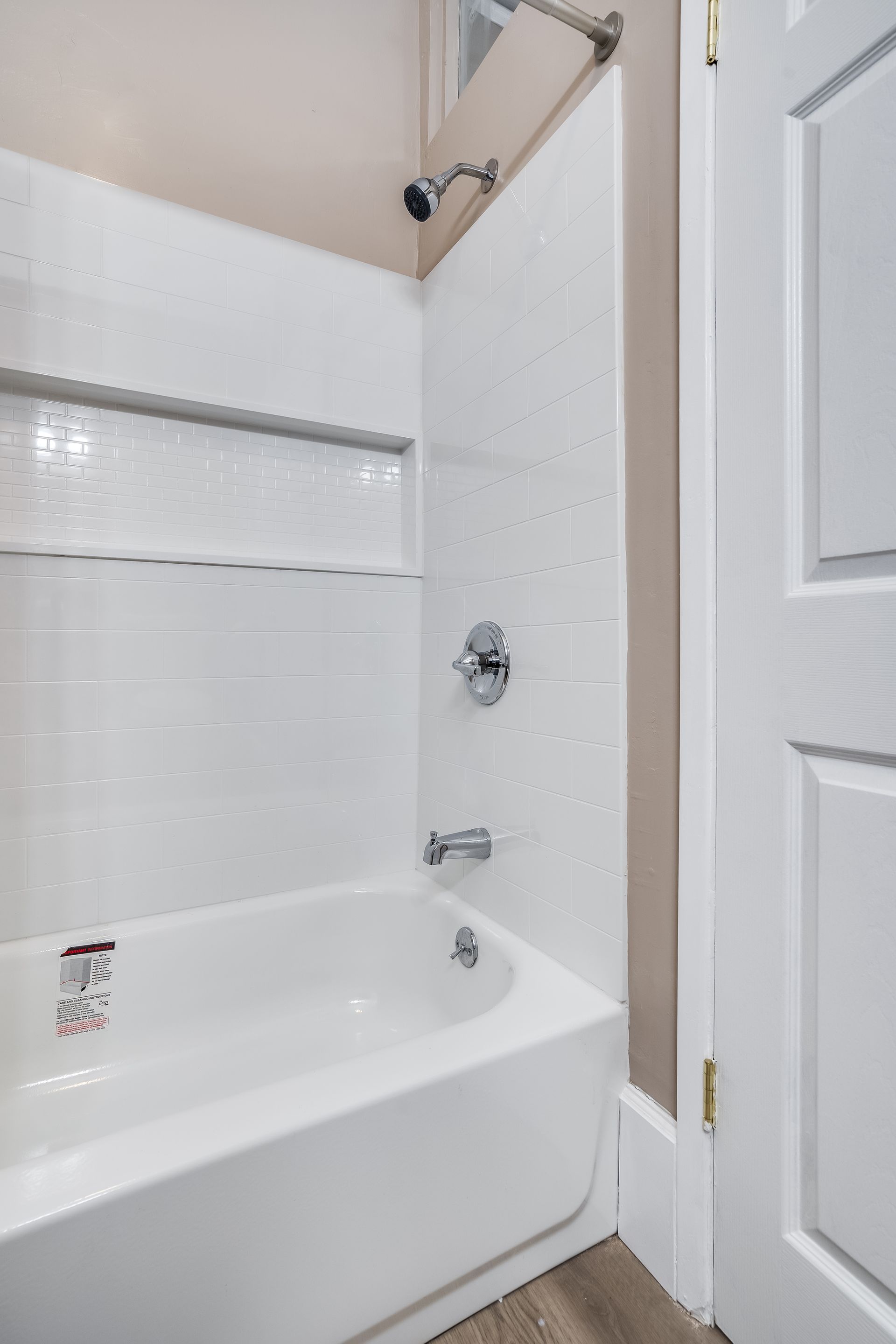 A bathroom with a bathtub and a shower.