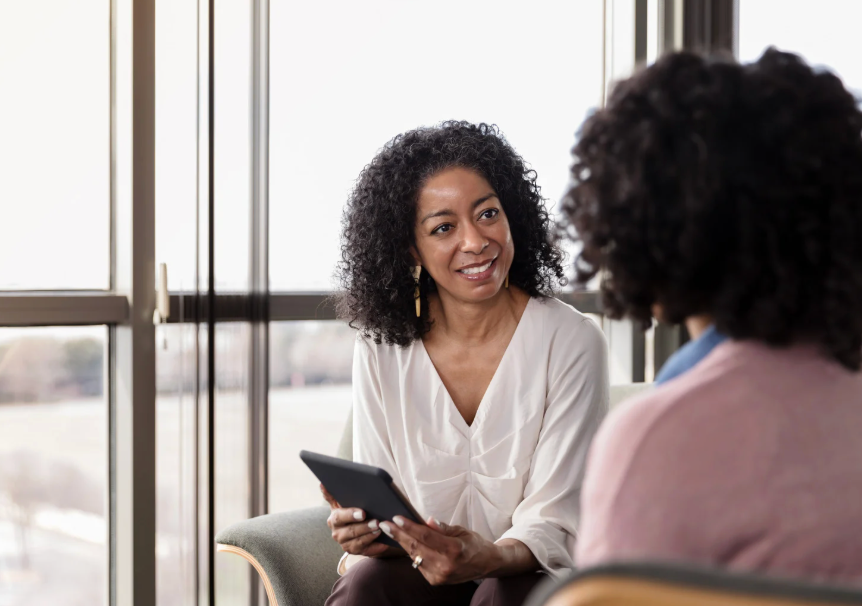 A living room with a couch and a flat screen tv on the wall.