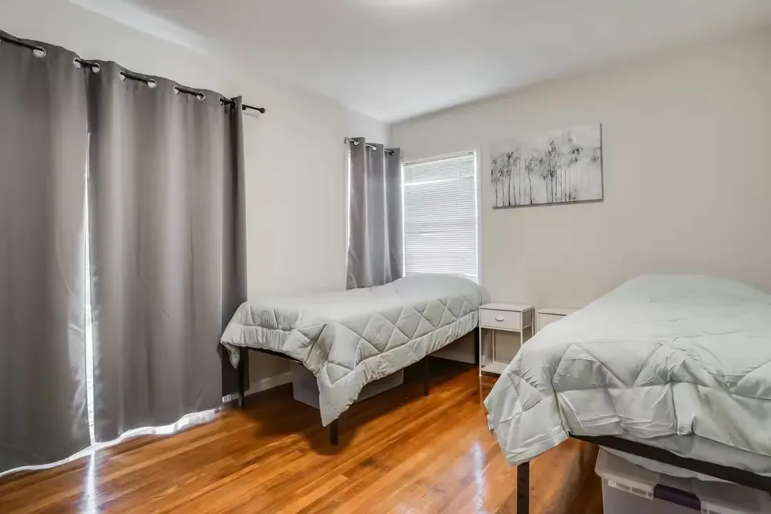 A long hallway with brown walls and wooden floors in a house.