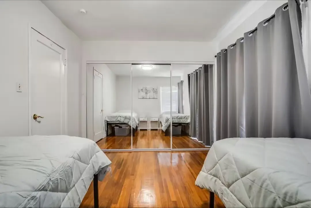 A kitchen with stainless steel appliances and white cabinets