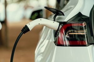 A close up of an electric car being charged.