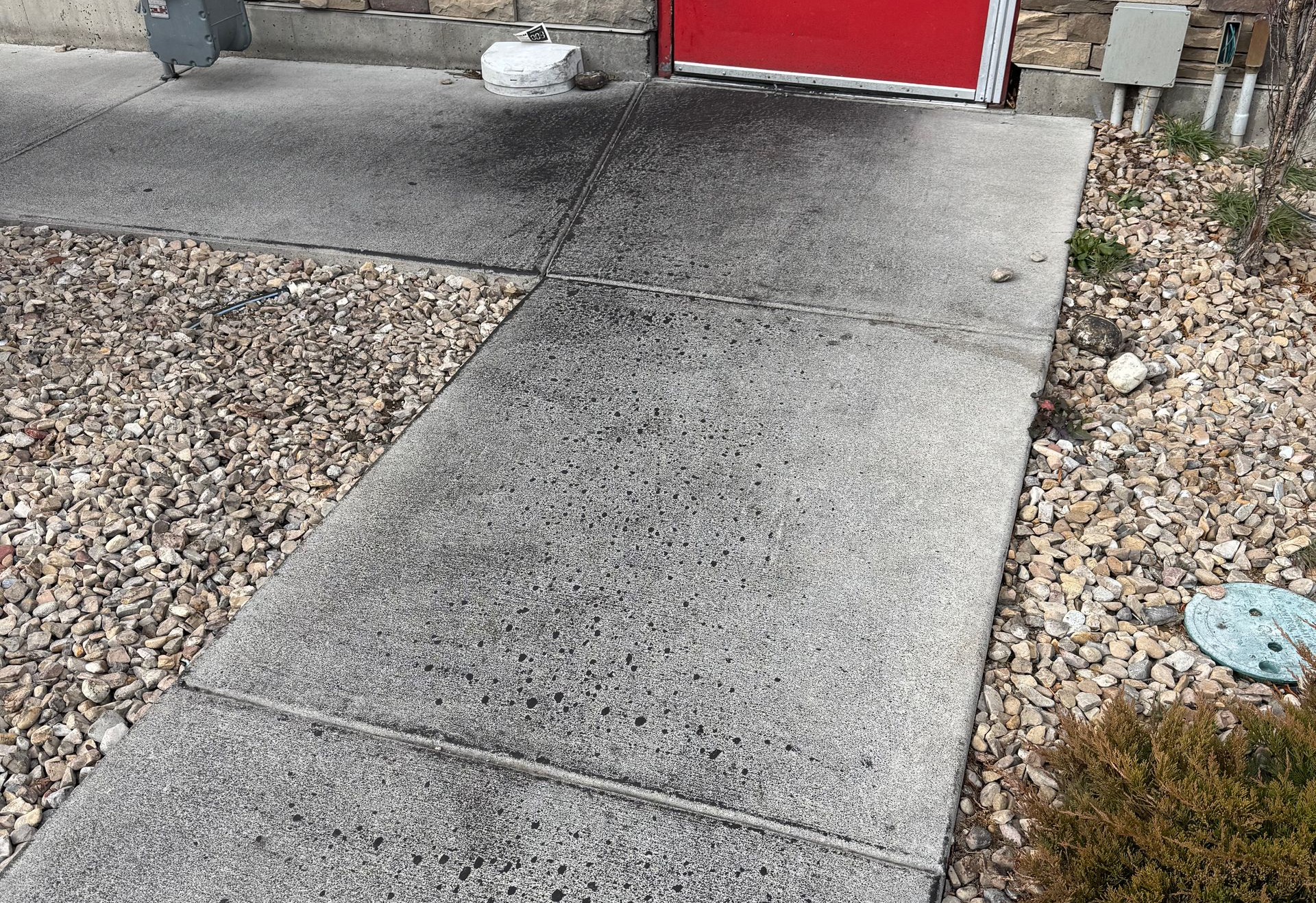 A before photo of a filthy concrete walkway