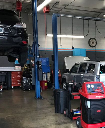 A car is sitting on a lift in a garage | The Garage in Renton