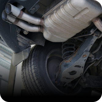 A close up of the underside of a car with exhaust pipes | The Garage in Renton