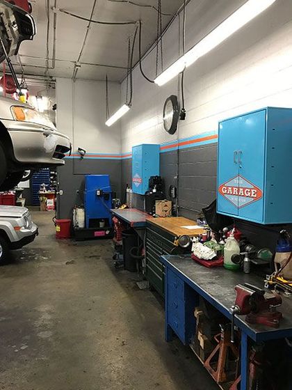 A car is sitting on top of a workbench in a garage. | The Garage in Renton