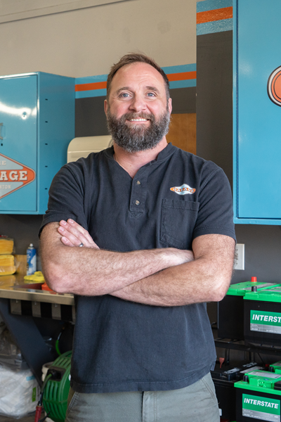 A close up of a man 's face with a beard and blue eyes. | The Garage in Renton