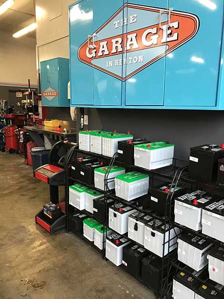 A bunch of batteries are stacked on top of each other in a garage. | The Garage in Renton