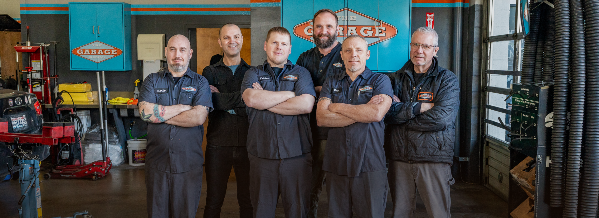 A group of men are posing for a picture in a garage. | The Garage in Renton