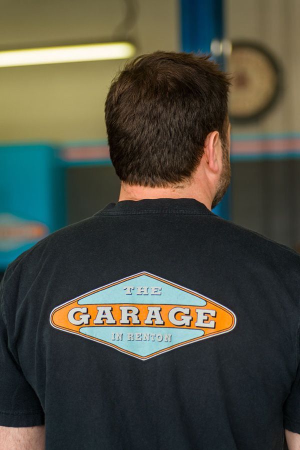 A man wearing a black t-shirt with the word garage on it | The Garage in Renton