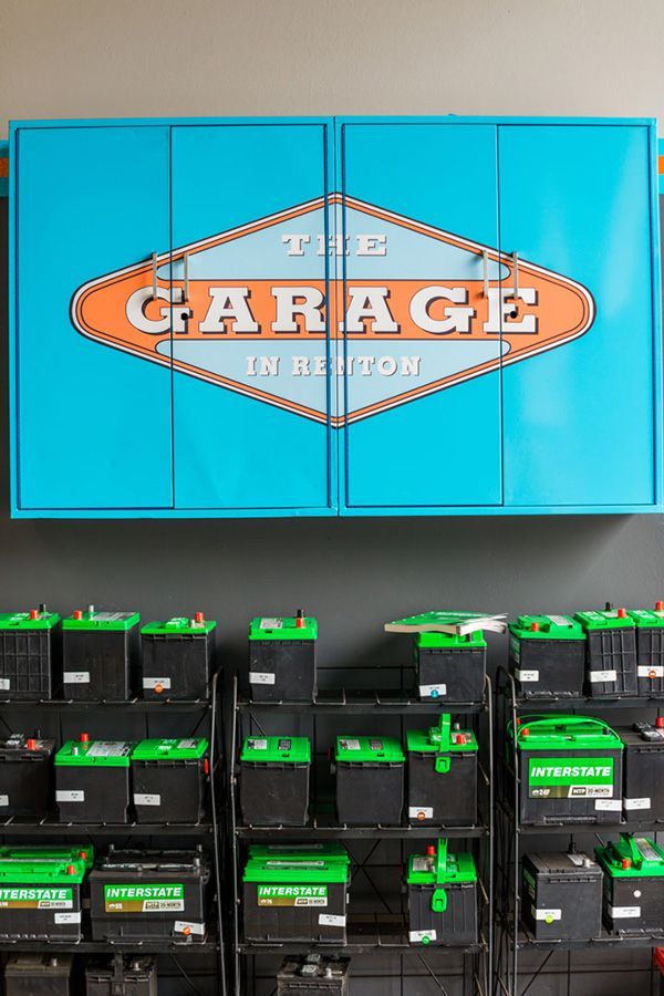 A garage filled with lots of batteries and a sign that says the garage in newton | The Garage in Renton