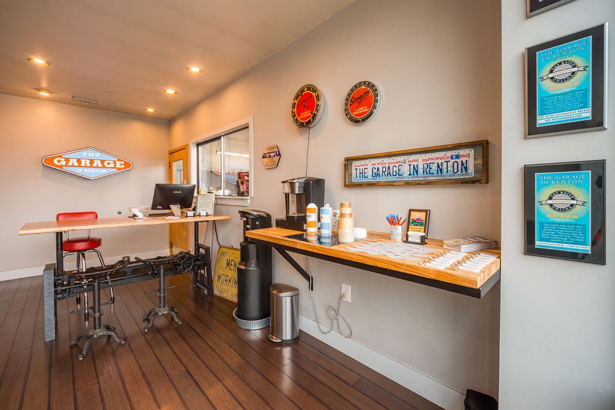 A room with a wooden floor , a desk and a computer. | The Garage in Renton