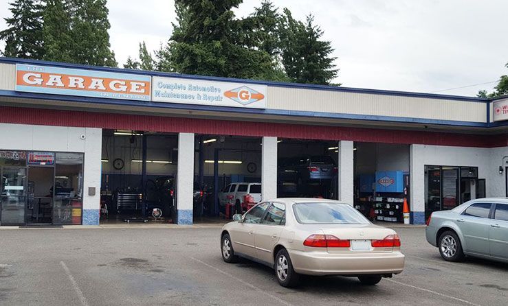 A car is parked in front of a garage | The Garage in Renton