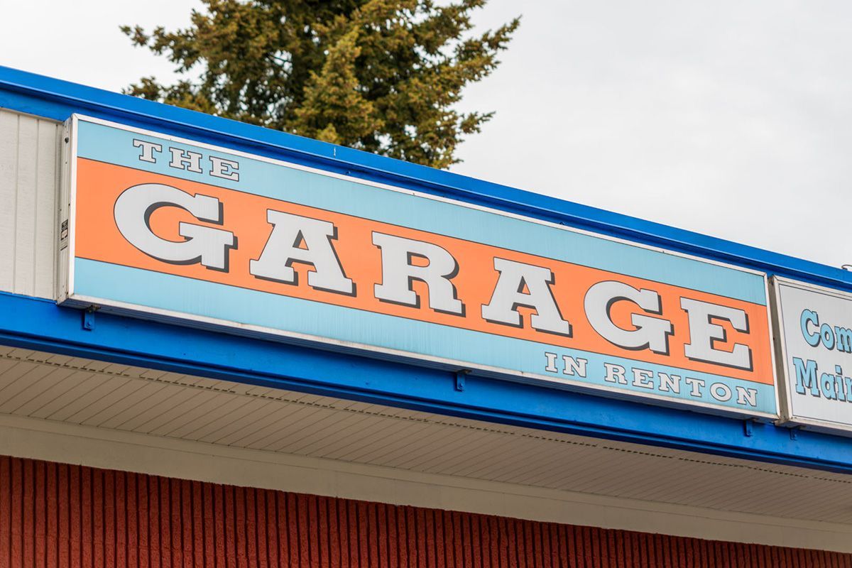 A blue and orange sign that says garage on it | The Garage in Renton
