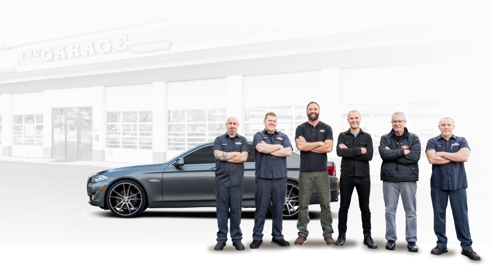 A group of men are standing in front of a car. | The Garage in Renton