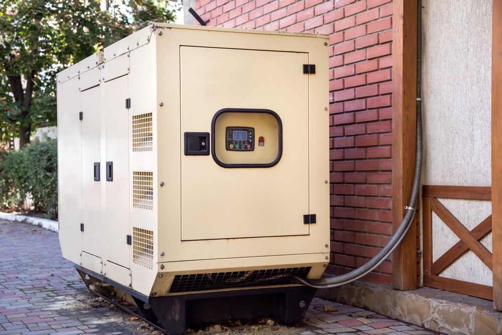 A Generator is Attached to the Side of a Brick Building — Aurablue Electric in Maitland, NSW