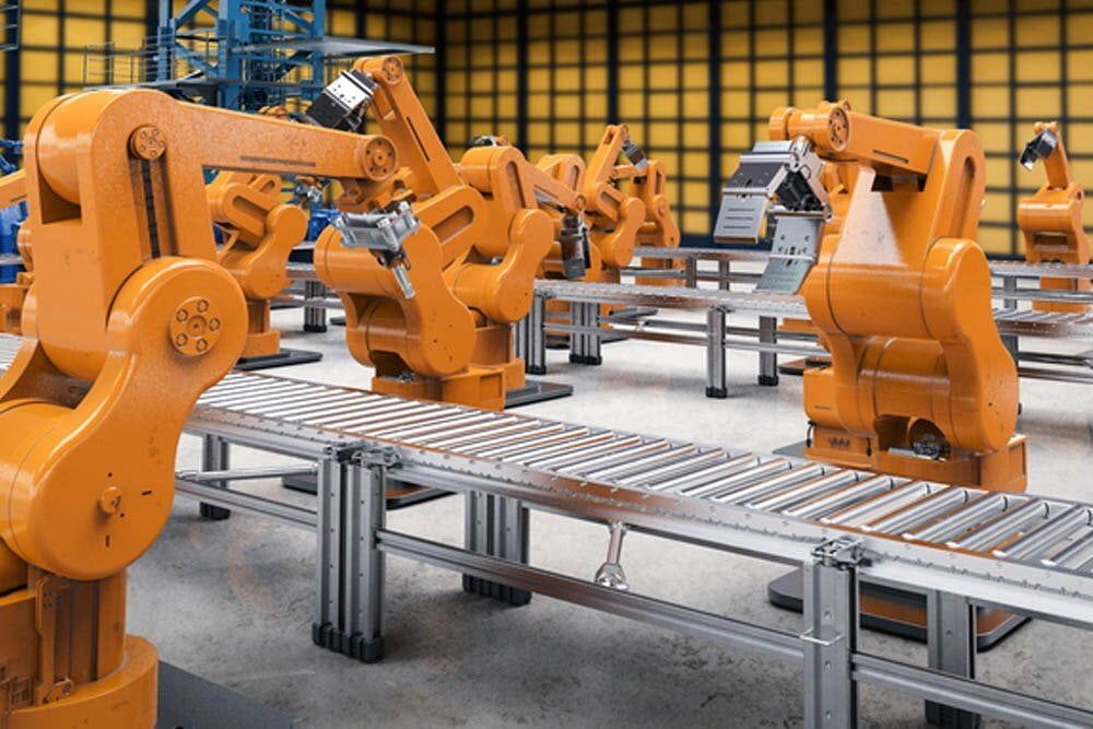 A Row of Orange Robots Are Sitting on a Conveyor Belt in a Factory — Aurablue Electric in Fullerton Cove, NSW