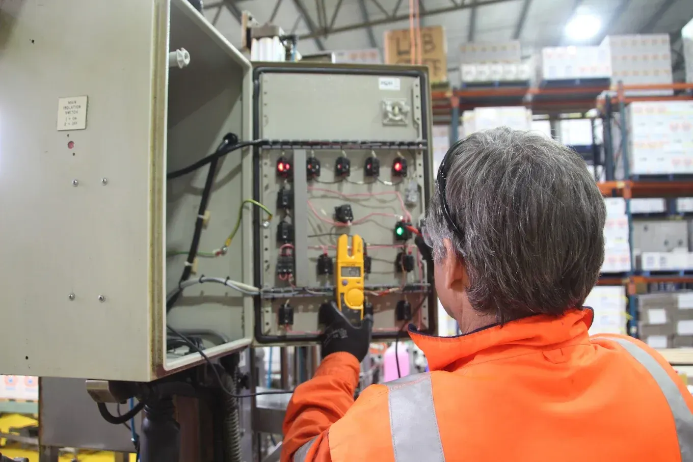 A man is checking inside switch board — Aurablue Electric in Fullerton Cove, NSW