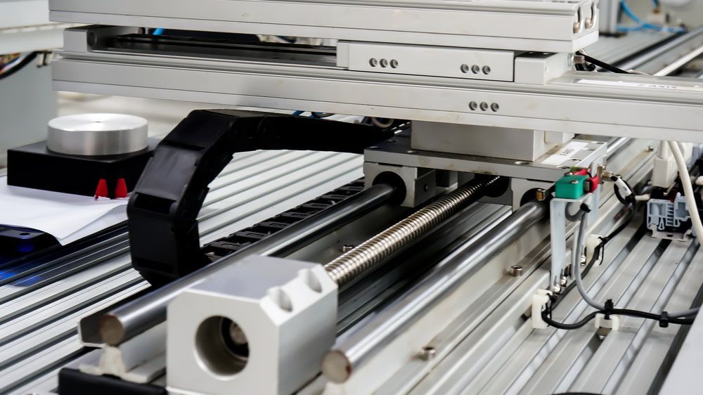 A Close Up of a Machine With a Conveyor Belt Attached to It — Aurablue Electric in Fullerton Cove, NSW