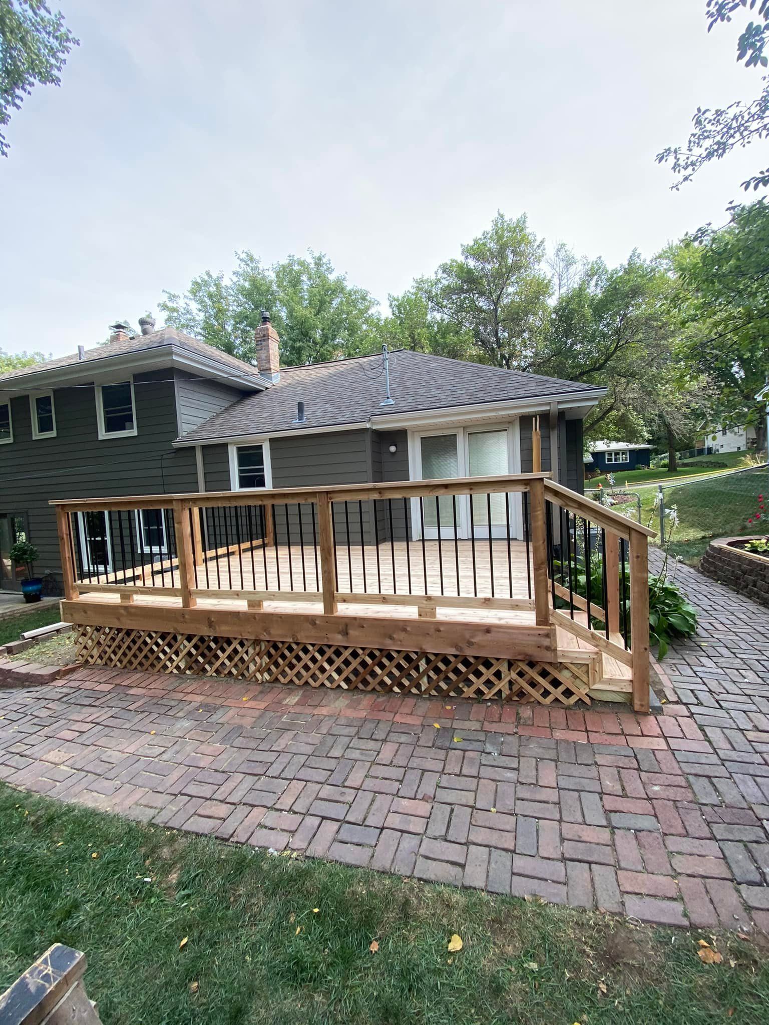 A house with a wooden deck in front of it.