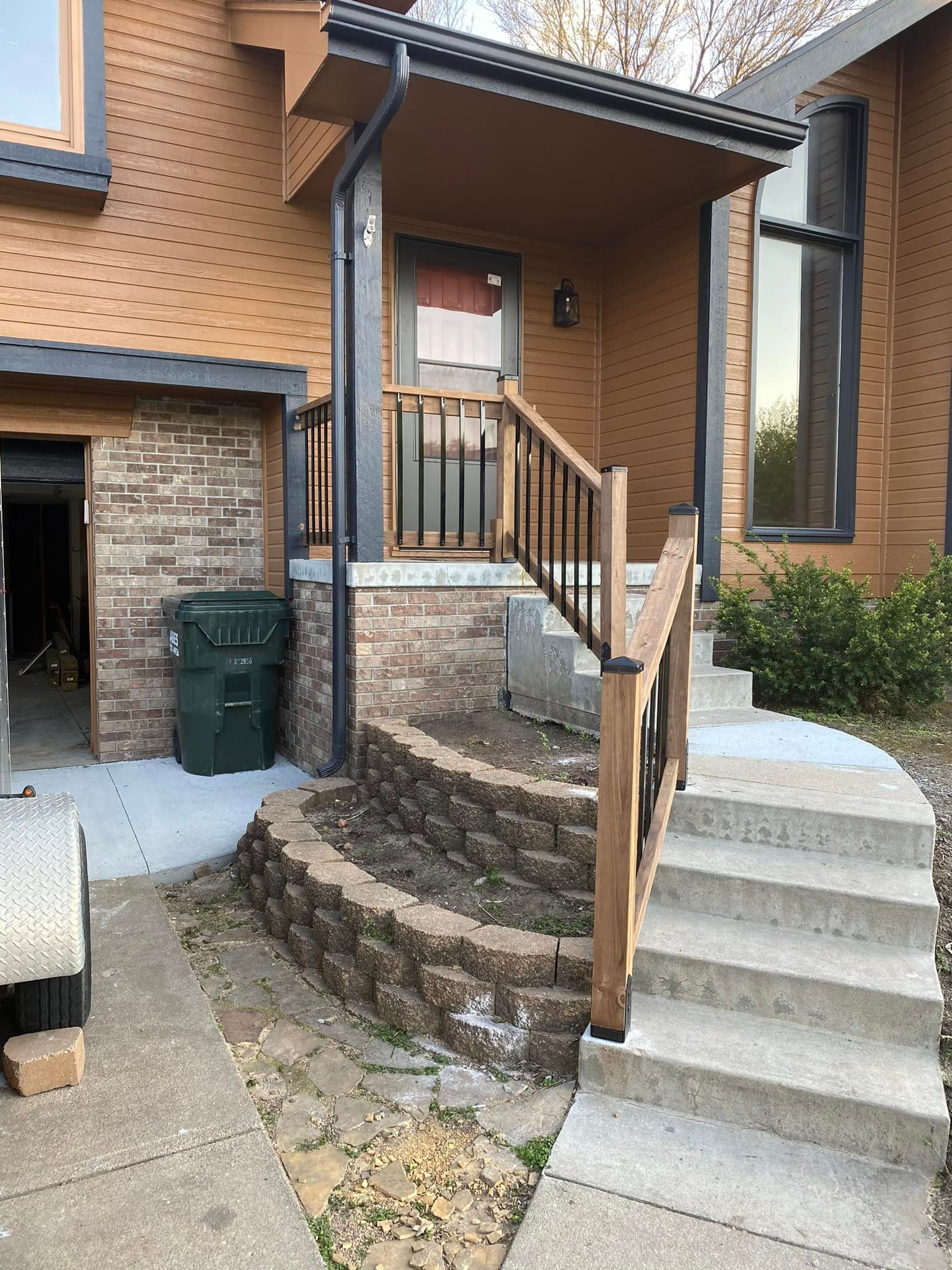 A house with a porch and stairs leading up to it.