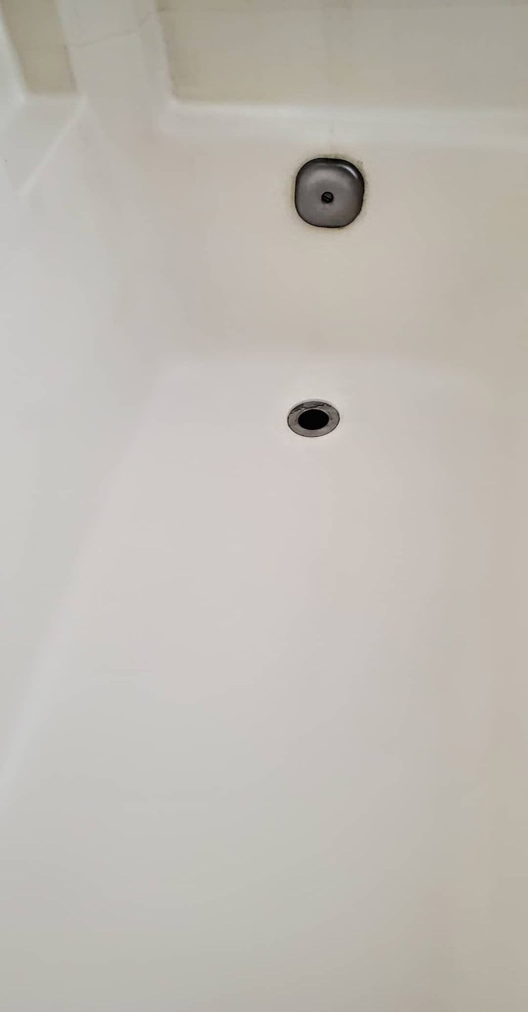 White bathtub with two drain openings.