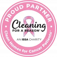 Pink and white logo for Cleaning for a Reason, an ISSA charity. Features a pink ribbon and text.