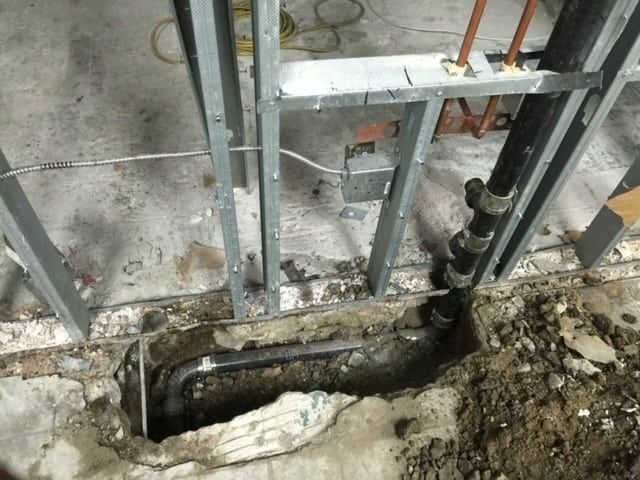 A Hole In The Ground With Pipes — Anaheim, CA — Accurate Plumbing and Drains