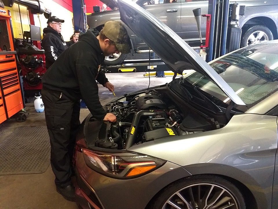 a man repairing a car | Forrest Automotive