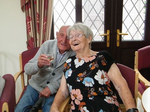 a carer and elderly lady having a fun laugh