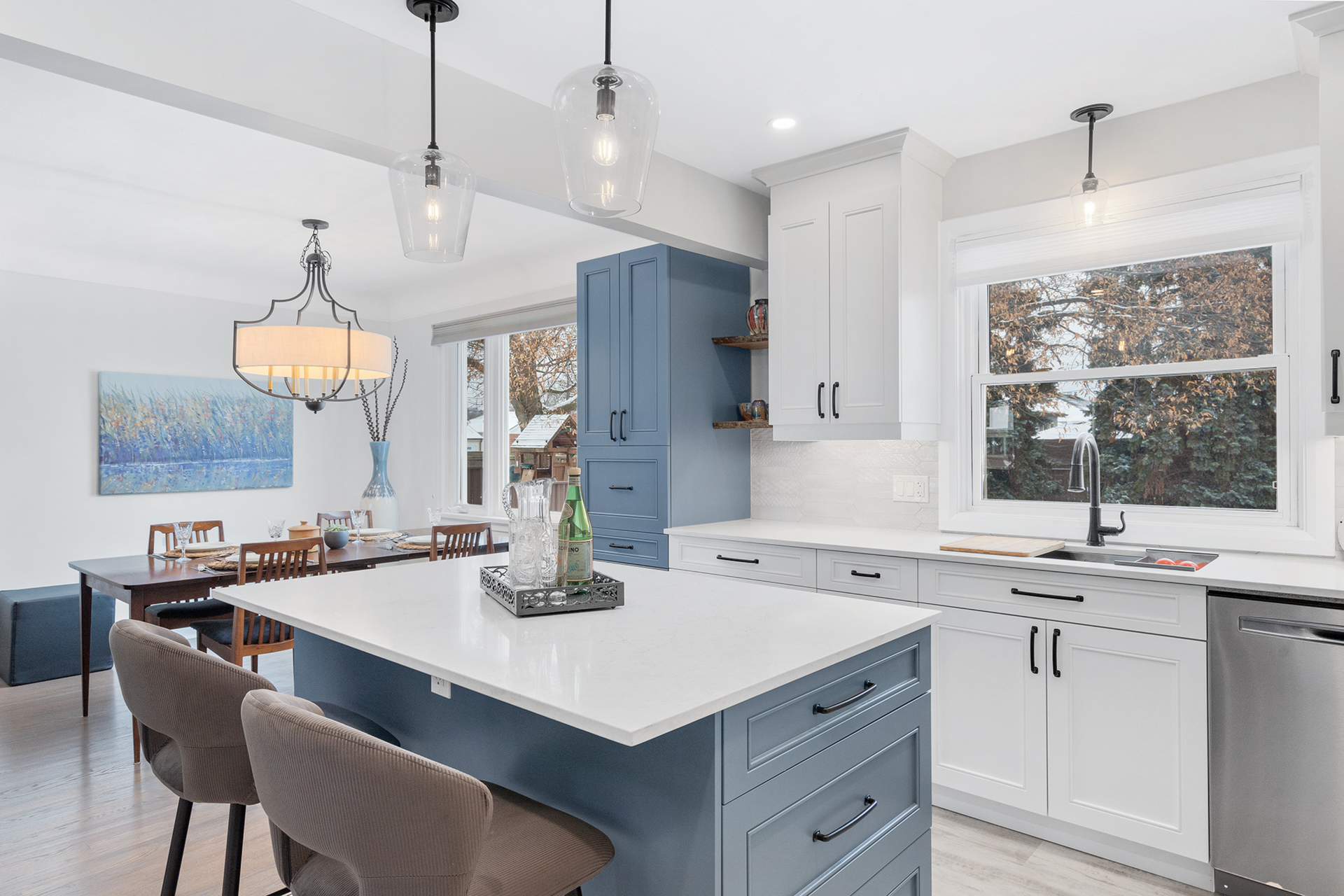 interior design in Dundas with cabinets, kitchen island with chairs, windows and sink