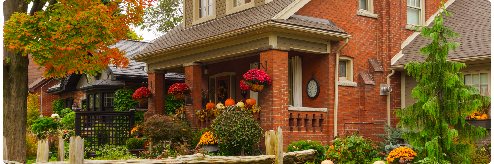 Efficient Home Design with welcoming front porch, seasonal decor, and well-planned landscaping for a functional home exterior.