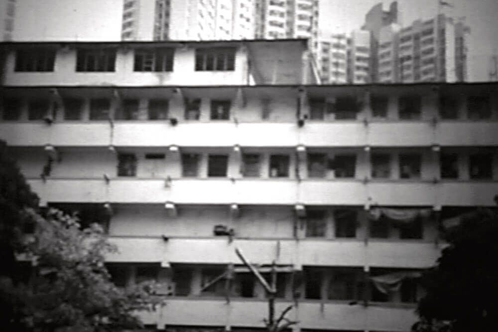 A black and white photo of a building with a lot of windows
