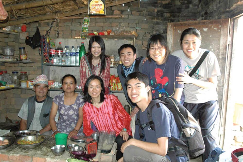 A group of people posing for a picture in a kitchen